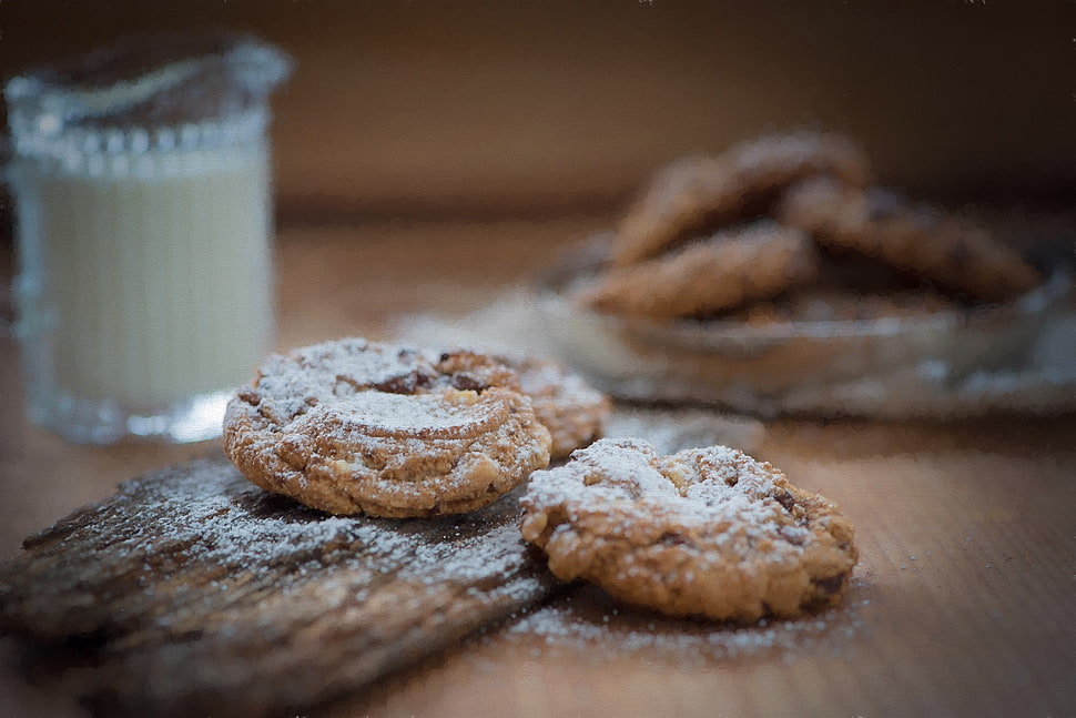 selective focus photography of cookies beside clear glass mug filled with white liquid on brown surface HD wallpaper