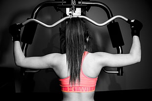 woman wearing orange sports bra doing exercise