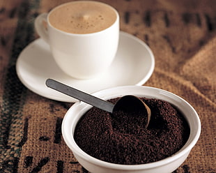 coffee grain on bowl beside teacup
