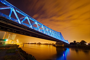 lighted metal bridge at night time
