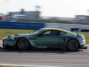 timelapse photography of green Aston Martin coupe on track