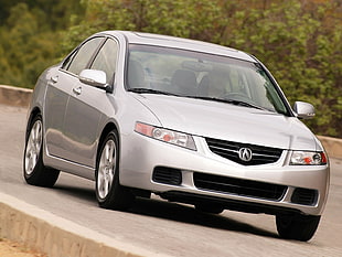 gray Acura TL on gray concrete road during daytime