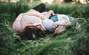 couple lying in the grass photo HD wallpaper