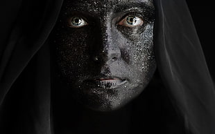 woman's face on black surface