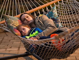 woman and girl on brown hammock