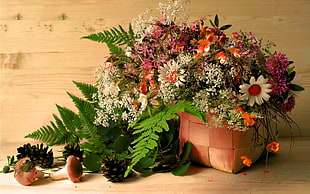 assorted-color petaled flower arrangement in brown basket