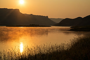 photography of hills and body of water during golden hour, missouri breaks