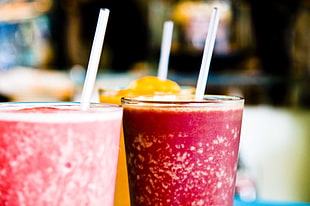 selective focus food photography of shakes on glasses with straws, java