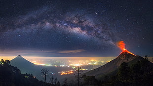 volcanic eruption under starry sky HD wallpaper