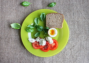 vegetable salad and bread served on green plate