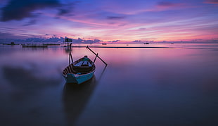 photography of gray canoe on body of water under purple sky during daytime, vietnam