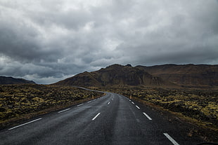 brown mountain range under gray cloudy sky during daytime