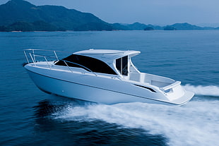 white speed boat on body of water photography