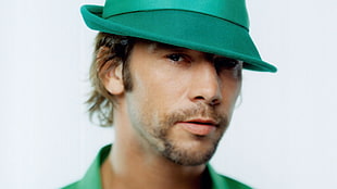 man in green fedora hat