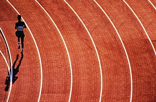 high angle photography of track and field contestant on field