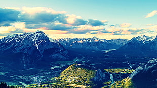 photo of snow half-covered mountain during cloudy sky