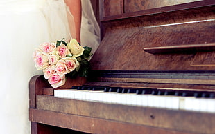 yellow and pink roses on piano