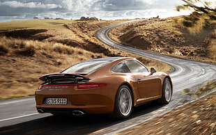 brown Porsche coupe passing by the road HD wallpaper