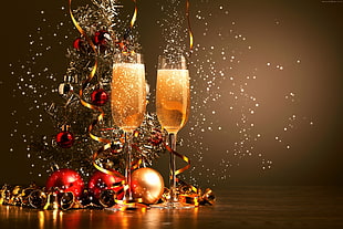 two champagne flutes beside baubles digital wallpaper