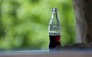 depth of field photography of Coca Cola bottle
