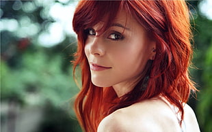 shallow focus photography of red hair woman