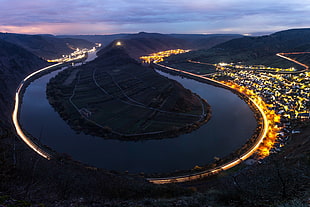 aerial photo of city skyline, night, river, light trails, long exposure