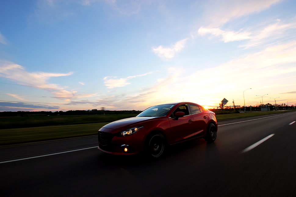 red sedan on asphalt road HD wallpaper