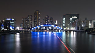 timelapse photo of white flat bridge, cityscape, artificial lights, night, long exposure