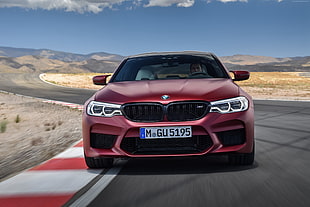 red BMW car on gray concrete road
