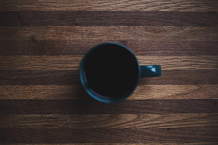 black ceramic mug on brown surface, wood, coffee