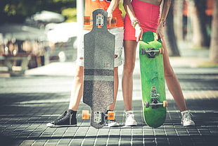 boy and girl holding skateboards HD wallpaper