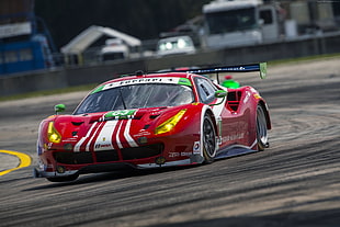 red Ferrari racing car on track HD wallpaper