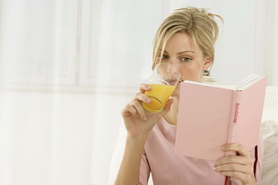 woman reading book and holding cup HD wallpaper