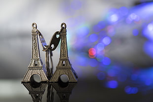 two grey Eiffel Tower keychains