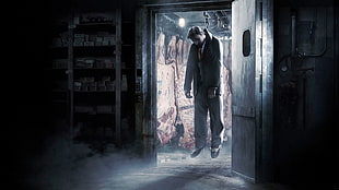 man wearing formal suit hang up at open door