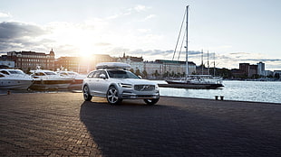 white Volvo SUV parked on the dock during daytime HD wallpaper
