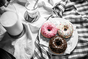 three dunkin donuts on white ceramic plate