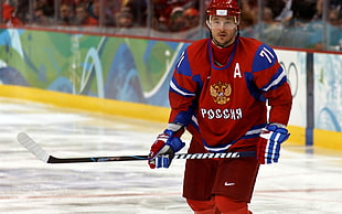 Ice hockey player wearing red and blue jersey