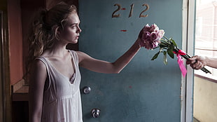 woman reaching bouquet of rose in front door HD wallpaper