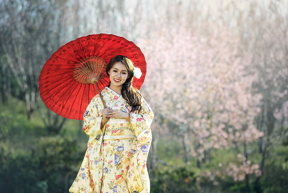 brown haired woman in yellow floral kimono dress holding umbrella during daytime HD wallpaper