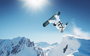 closeup photo of person riding snowboard on mountain cover by snow