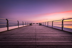 photo of brown wooden bridge during sunset