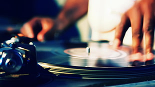 person playing vinyl disc