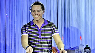 man wearing headphones while smiling
