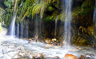 man standing beneath the falls