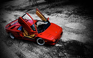 parked red coupe with doors opened