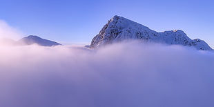 high rise snow mountain with fog