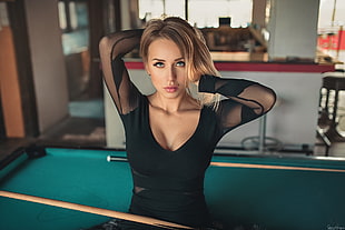 woman sitting on pool table