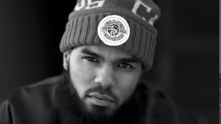 man wearing Cleveland Cavaliers beanie greyscale photo