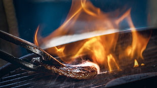 black metal tong, grill, steak, fire